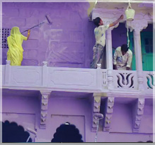 Woman in India Painting House Purple.
